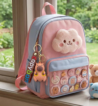 Capybara keychain hanging from blue and pink backpack on windowsill with plush toys nearby