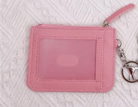 Back view of pink PVC coin purse showing clear card window and silver keyring clip