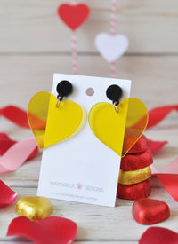 Yellow transparent perspex heart earrings with black stud tops on Kaboodle Designs card
