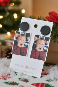 Pair of Kevin drop earrings on card displayed among Christmas decorations