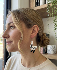 Duck goose earring worn on model's ear, side profile view