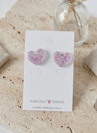 Pink and blue glitter resin heart stud earrings displayed on a Kaboodle Designs card