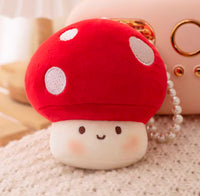 Close-up front view of plush mushroom charm showing embroidered face and polka-dot cap