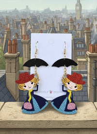 Acrylic Mary Poppins-style drop earrings with black umbrella and glitter dress on card against London rooftop backdrop