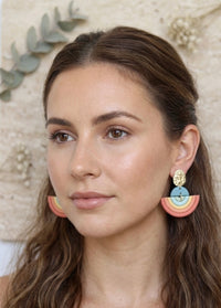 Model wearing clay rainbow arch earrings, side profile close-up view
