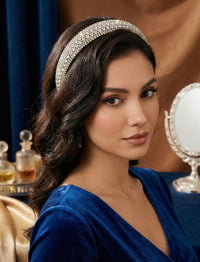 Model wearing sparkling diamante statement headband with dark wavy hair styled back