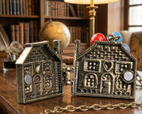 Balloon house locket opened to show hinged interior compartments on wooden desk