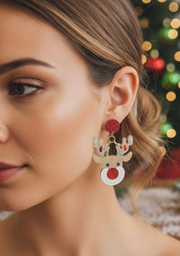 Close-up of Rudolf reindeer earring worn on ear showing red glitter nose detail