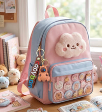 Capybara keychain with rainbow "capybara" tag hanging from a pink and blue backpack, front view