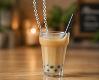 Side view of resin bubble tea pendant showing tapioca pearls and straw detail