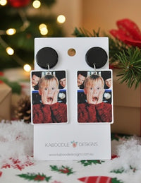 Acrylic Kevin drop earrings on white Kaboodle Designs card with festive backdrop