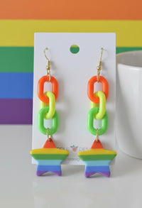 Rainbow chain-link earrings with striped star charm on Kaboodle Designs card, rainbow background