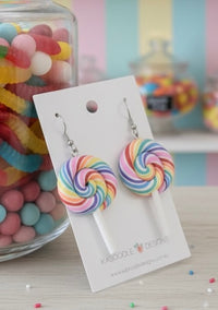 Rainbow swirl lollipop earrings on Kaboodle card, front view showing candy stick detail