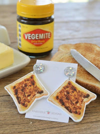 Vegemite toast drop earrings displayed on a Kaboodle Designs card next to a Vegemite jar and toast