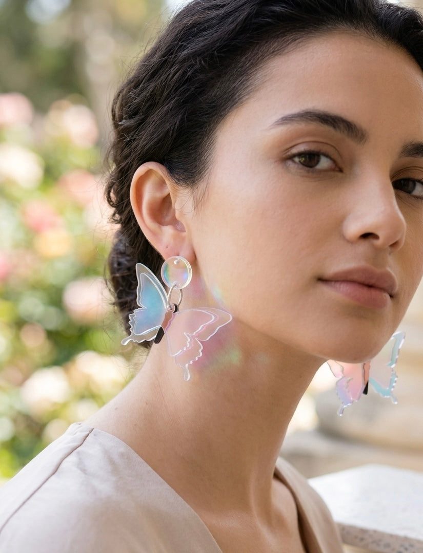 Iridescent butterfly earring worn on model's ear, close-up side view