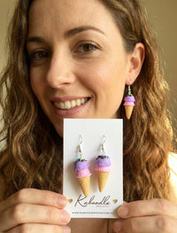 Ice cream cone earring worn on ear, shown alongside matching pair on backing card