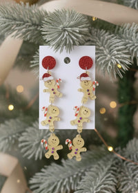 Acrylic gingerbread man drop earrings with Santa hat and candy canes on card, hung on Christmas tree