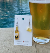 Resin beer bottle drop earring with sticker label, paired with a resin beer glass earring on a card