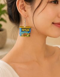 Close-up of a single SPAM Lite tin earring worn on a model's ear