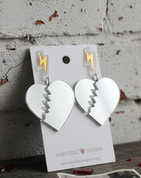 Mirror acrylic broken heart earrings with gold lightning bolt studs on Kaboodle Designs card