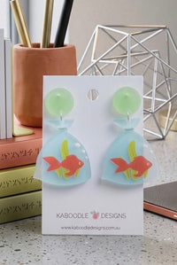 Perspex earrings shaped like goldfish in plastic bags with green stud tops, on Kaboodle Designs card