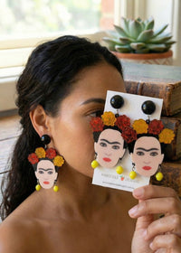 Woman wearing Frida Kahlo rose crown drop earrings, close-up side profile