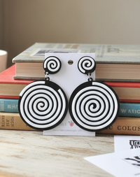 Black and white spiral drop earrings on card, showing round swirl design and stud top
