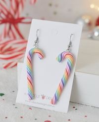 Rainbow striped polymer clay candy cane drop earrings on a Kaboodle Designs card