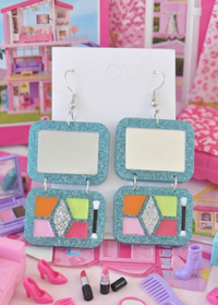 Blue glitter makeup palette drop earrings on card, showing mirror top and eyeshadow tray below