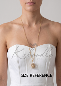 Carousel pendant necklace worn on a model, resting on chest for size reference