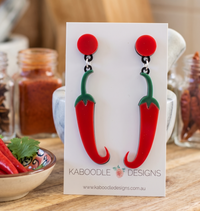 Red and green Perspex chilli pepper drop earrings on Kaboodle Designs card backing