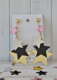 Acrylic star drop earrings on card with pink, white, black and gold mirror stars cascading on gold chain