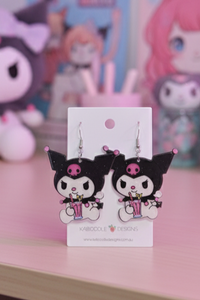 Black and pink acrylic cartoon rabbit drop earrings on a white Kaboodle Designs card