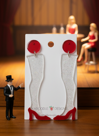 Red stiletto leg drop earrings on white card with red disc studs, glitter detail visible