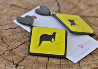 Close-up of kangaroo crossing sign earrings showing laser-cut silhouette and glossy acrylic finish