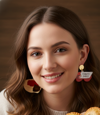 Model wearing the tomato sauce bottle acrylic earring as a close-up on-ear shot