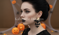 Woman wearing black glitter bat drop earrings with gold moon stud, side profile with dark makeup