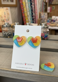 Colour-block heart resin stud earrings on Kaboodle Designs card, showing glitter finish in green, orange, blue, yellow and