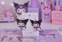 Acrylic rabbit drop earrings displayed on card against a pastel pink backdrop