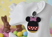 Close-up of egg-shaped mouse earring worn on ear showing glitter and polka dot detail