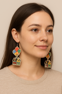 Balloon house wooden earrings worn on model's ear, close-up side view