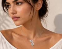 Close-up of model wearing double leaf cutout necklace resting at the collarbone