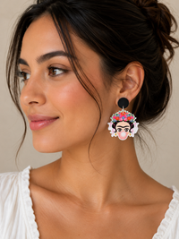 Close-up of bubble gum drop earring worn on ear, showing floral crown and pink bubble detail