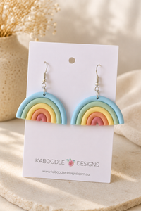 Pastel clay rainbow drop earrings on Kaboodle Designs card, showing blue, green, yellow, orange and pink arcs
