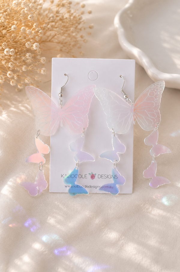 Pair of iridescent Perspex butterfly earrings on Kaboodle Designs card, front view