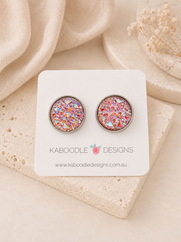 Pink faceted druzy-style stud earrings on a Kaboodle Designs display card