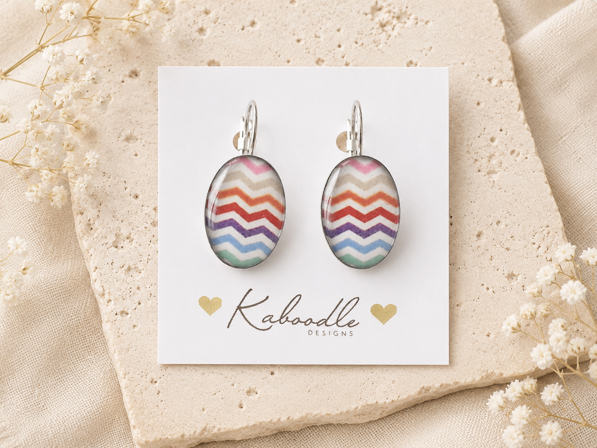 Oval clip earrings with rainbow chevron pattern displayed on a Kaboodle Designs card
