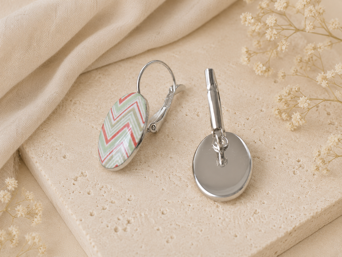 Side view of chevron clip earring showing lever-back mechanism and plain silver reverse