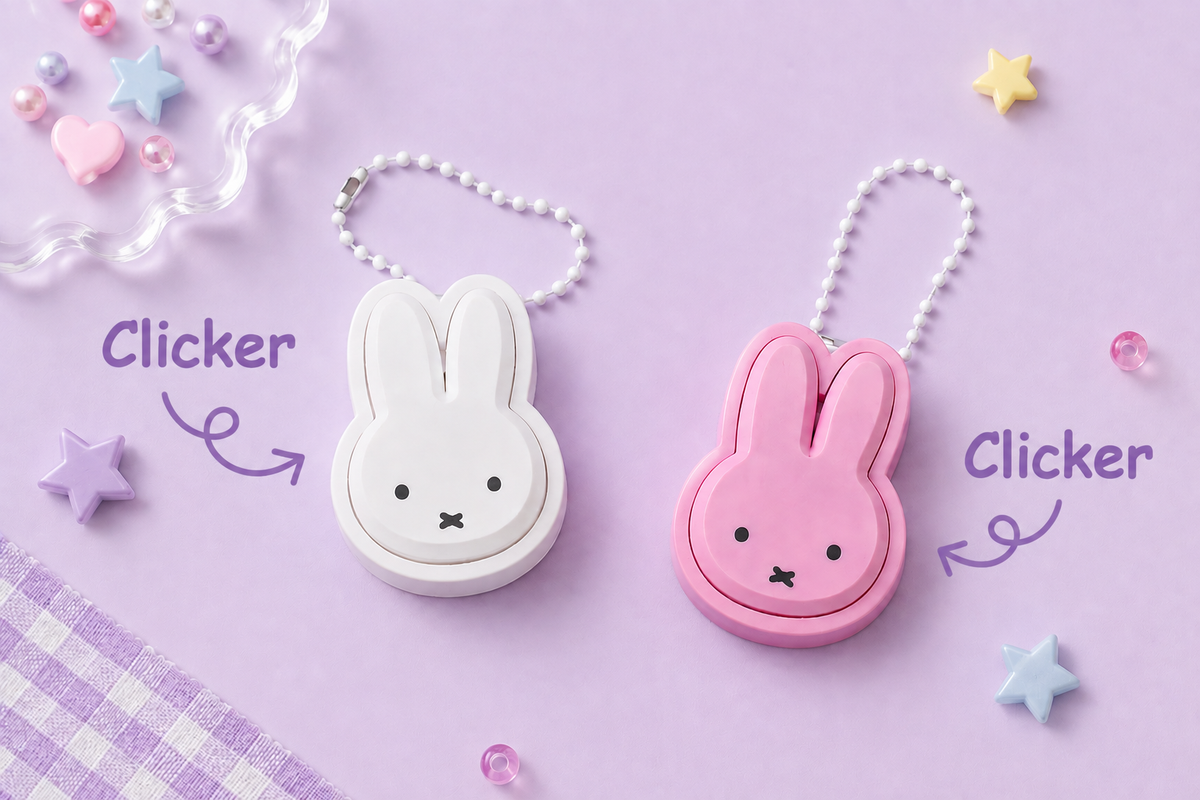 White and pink Miffy-shaped clicker keychains with bunny ear cases and beaded ball chain attachments.