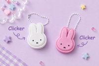White and pink Miffy-shaped clicker keychains with bunny ear cases and beaded ball chain attachments.